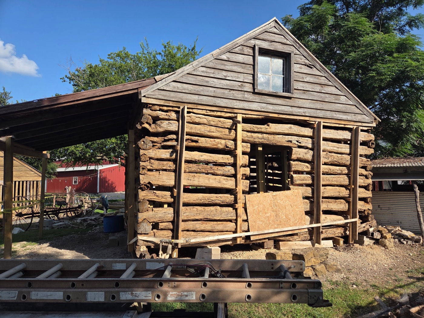 Gable end of the Campbell Log Cabin showing hand-hewn logs and the original loft window